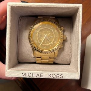 Gold tone stainless steel mens Michael Kors watch.